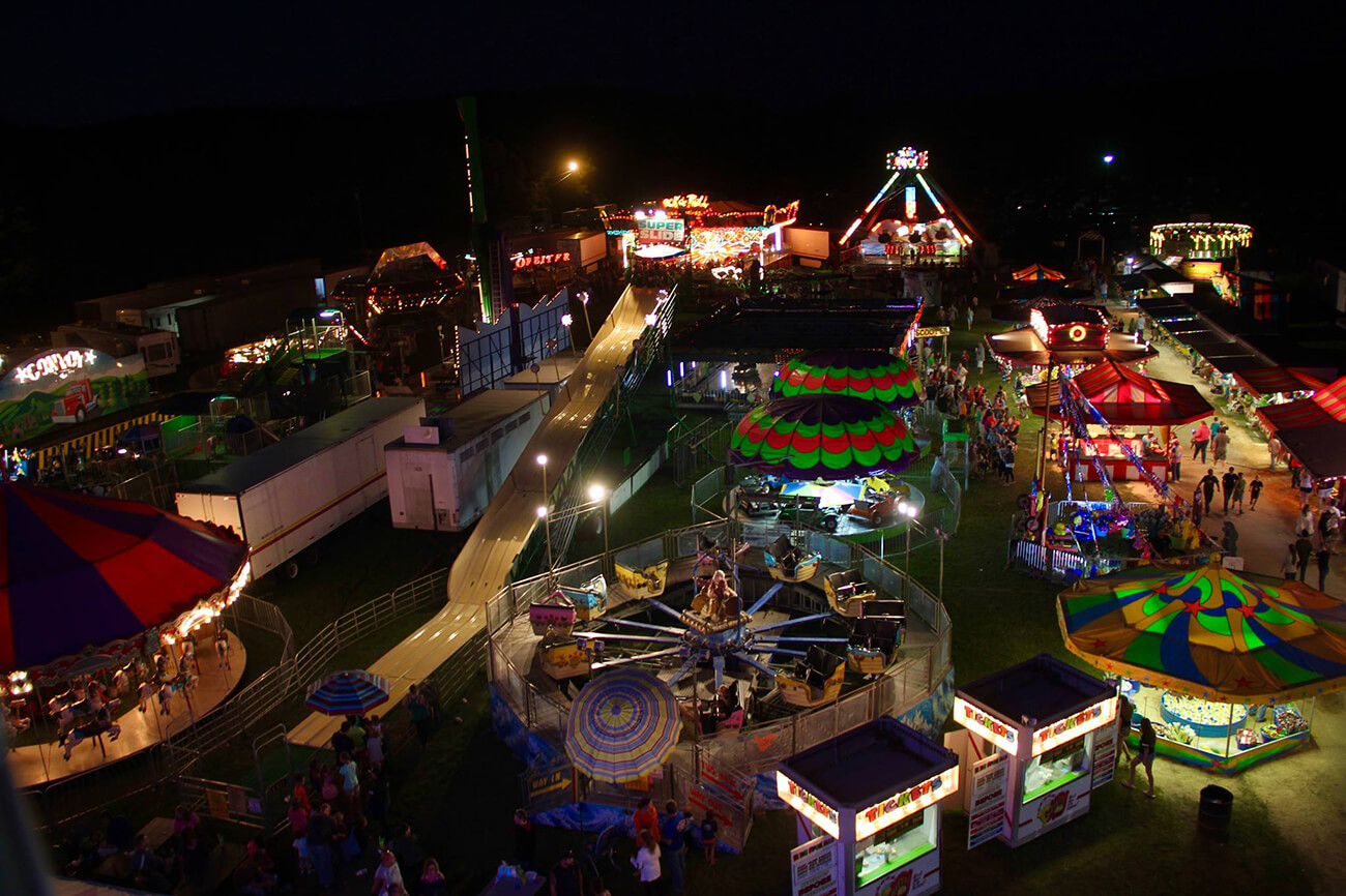 Seen from above, the Otsego County Fair midway shines with brilliant colorful light at night